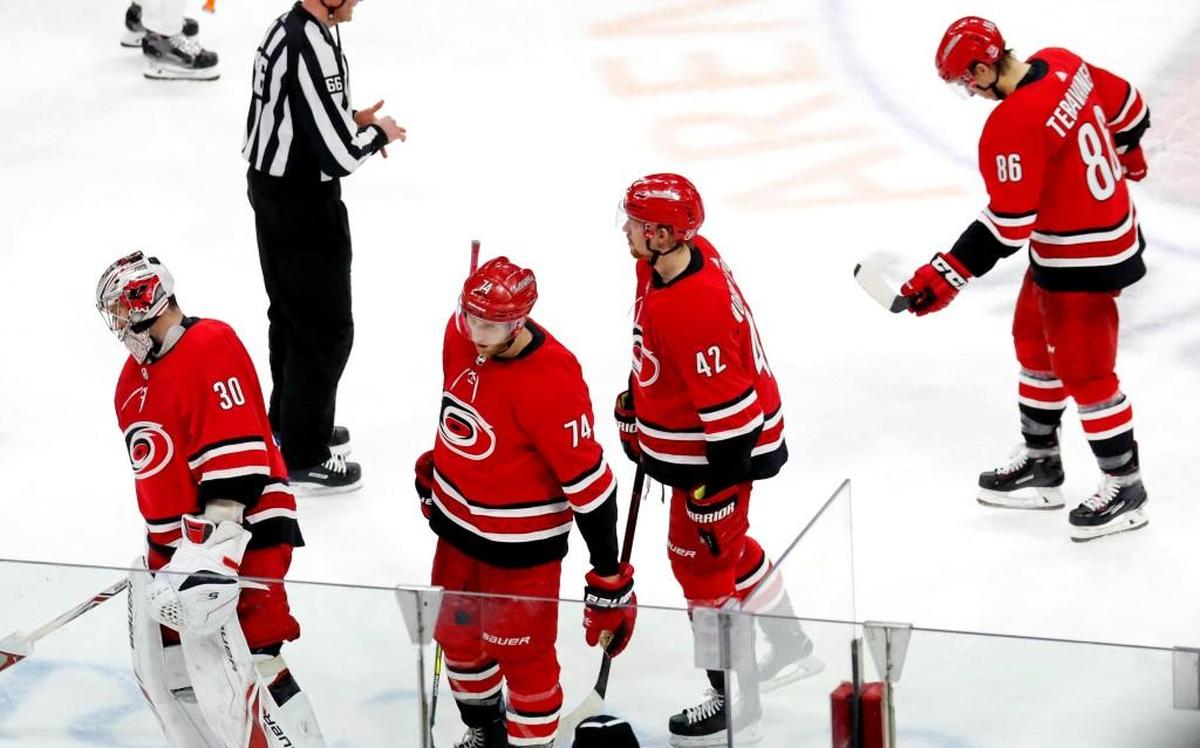 Disappointed Hurricanes players Cam Ward (30), Jaccob Slavin (74), Joakim Nordstrom (42) and Teuvo Teravainen (86) skate off the ice after the Flyers' Jordan Weal scored the game-winning goal in the final seconds of the overtime period in an NHL game played between the Carolina Hurricanes and the Philadelphia Flyers at PNC Arena in Raleigh, N.C. on Feb. 6, 2018. The Flyers beat the Canes 2-1 in overtime.