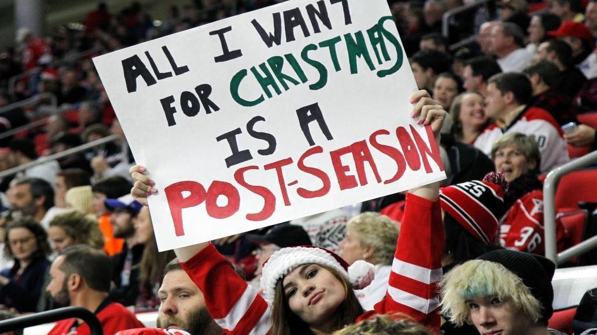 A Canes fans holds a sign showing her desire for a playoff berth during the game between the Carolina Hurricanes and the Florida Panthers at PNC Arena in Raleigh on Dec. 18, 2015.