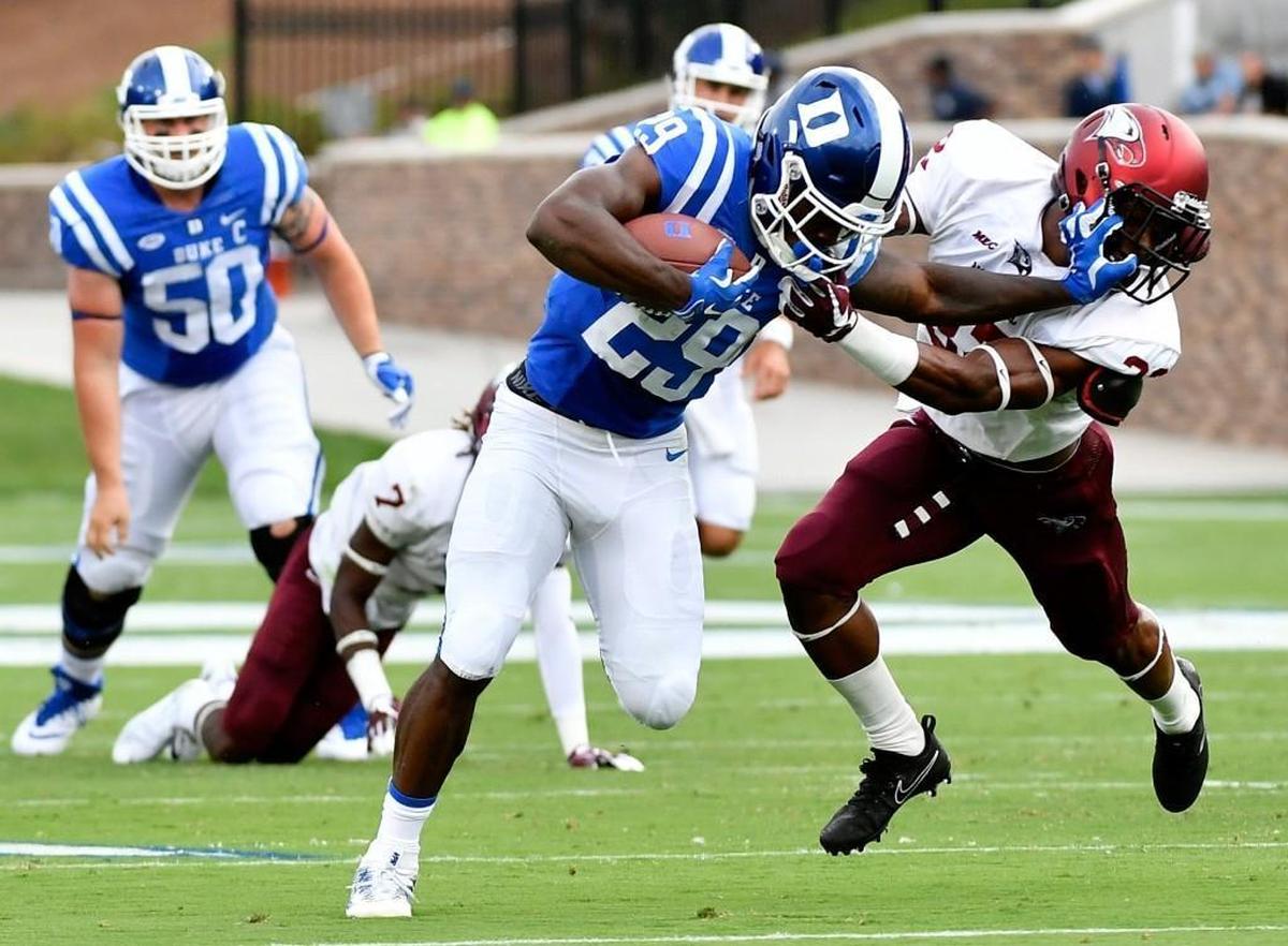 Duke running back Shaun Wilson stiff-arms defensive back Alden McClellon of North Carolina Central at Wallace Wade Stadium on September 2, 2017. (Photo by Mike Comer/Getty Images)