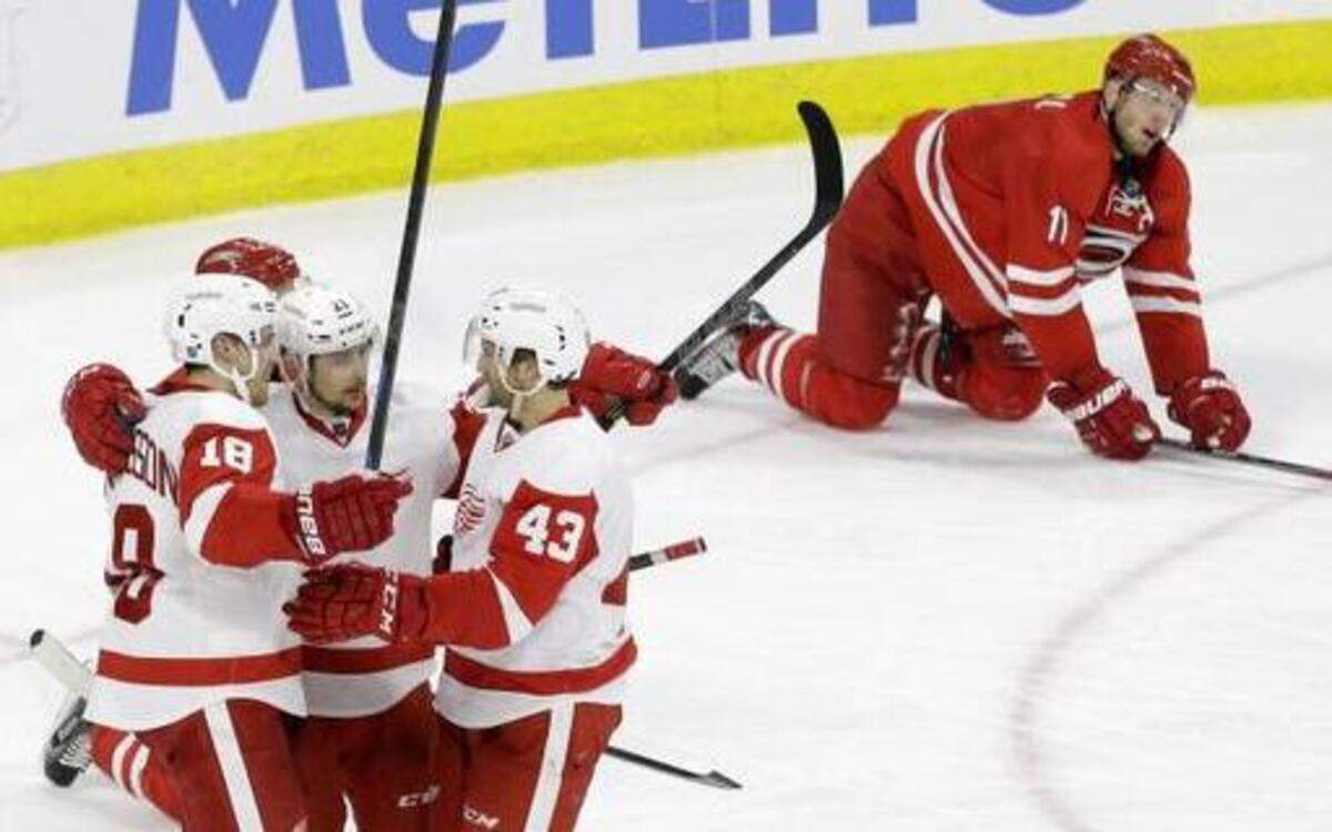 
The Canes’ Jordan Staal (11) on the ice as the Red Wings' Joakim Andersson (18) celebrates his empty-netter with Tomas Tatar (21) and Darren Helm (43) late in the Hurricanes 2-0 loss to Detroit to end the season..
