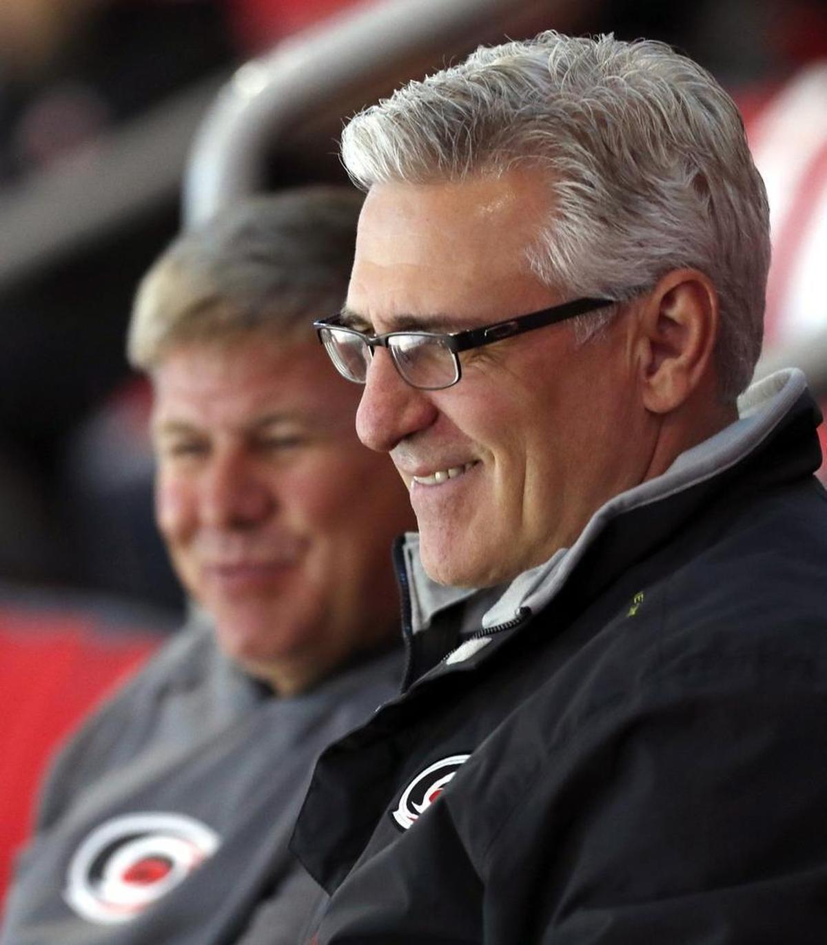The Carolina Hurricanes head coach Bill Peters, left, and general manager Ron Francis watch the skaters as the team holds prospect camp for young hopefuls at PNC Arena on June 29, 2017.