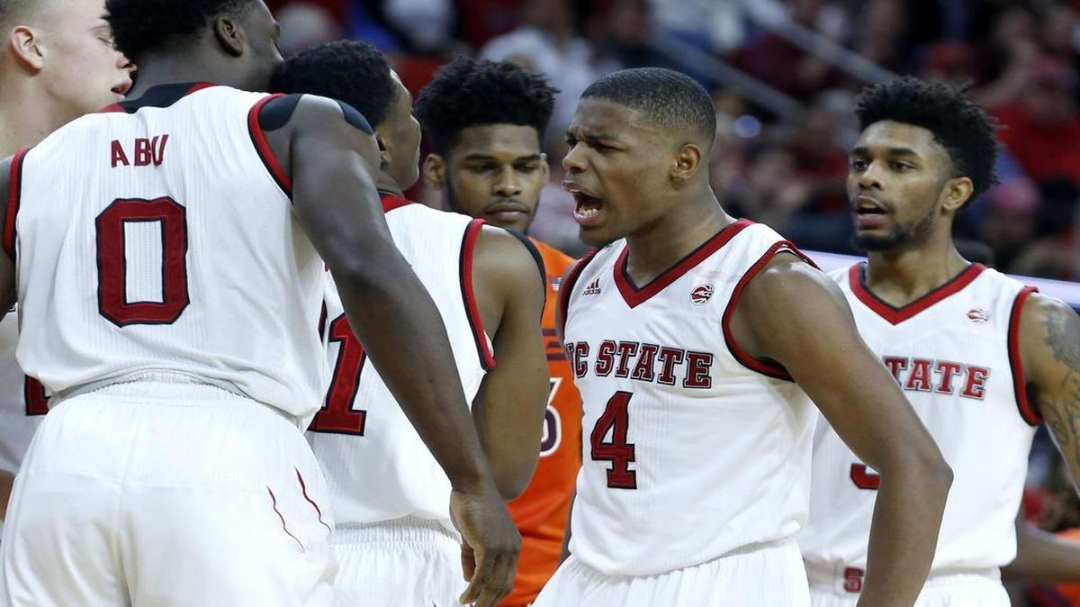 N.C. State's Dennis Smith Jr. (4), center right, celebrates with Markell Johnson (11), left, after Johnson stole the ball during N.C. State's 104-78 victory over Virginia Tech at PNC Arena on January 4, 2017.