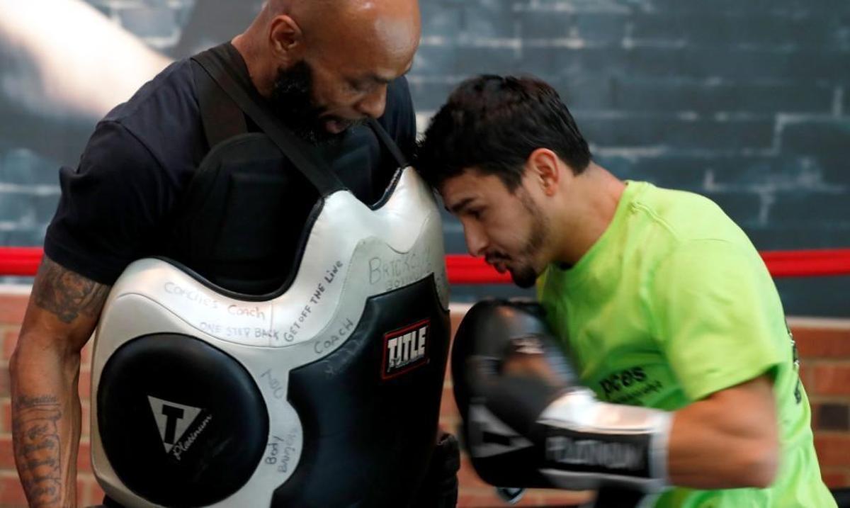 Carlos Olmeda works out with coach Derrick Reed during open workouts at Title Boxing Gym in Cary on Oct. 12, 2017. He fights Thursday night at the Durham Armory.