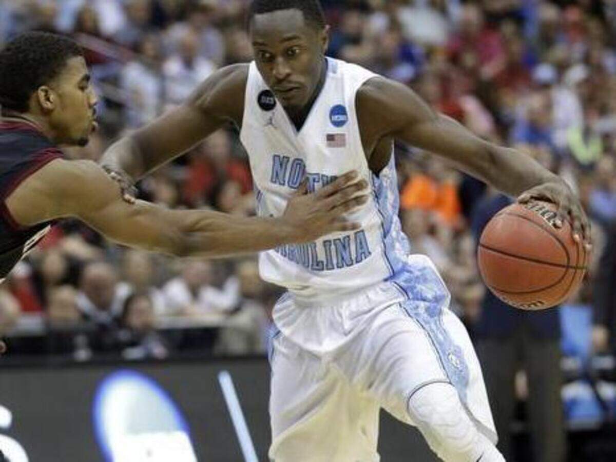 
North Carolina forward Theo Pinson, right, pushes his way around Harvard guard Wesley Saunders during the second half of an NCAA tournament second round college basketball game Thursday, March 19, 2015, in Jacksonville. 
