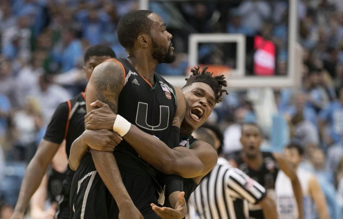 Miami’s Lonnie Walker IV (4) embraces teammate JaíQuan Newton (0) after he hit the game winning shot to give Miami a 91-88 victory over North Carolina with :01 to pay in the game on Tuesday, February 27, 2018 at the Smith Center in Chapel Hill, N.C.