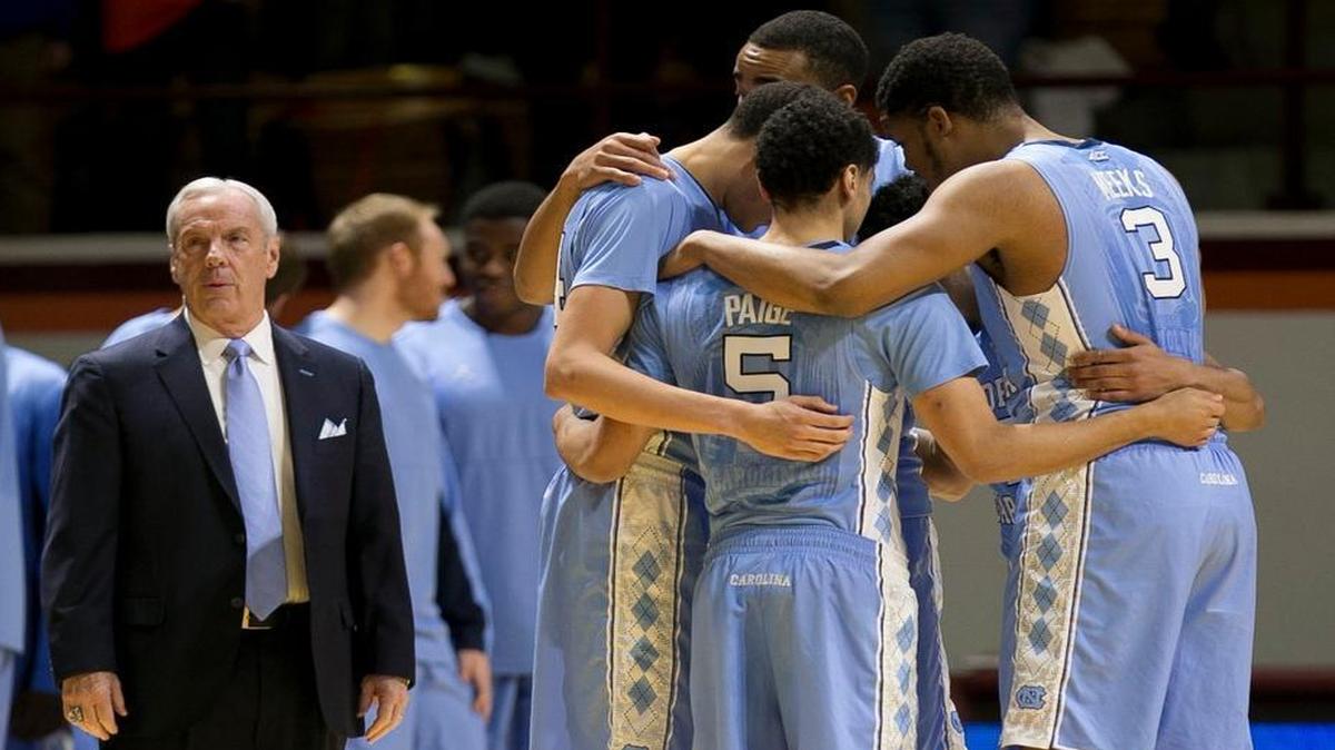 North Carolina coach Roy Williams waits while his starters huddle prior to the game against Virginia Tech on Sunday at Cassell Coliseum in Blacksburg, Va.