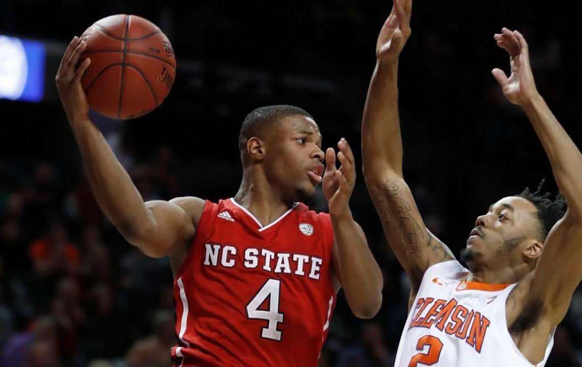 Former N.C. State guard Dennis Smith Jr. (4) passes around Clemson’s Marcquise Reed (2) during the second half of Clemson’s 75-61 victory over N.C. State in the ACC tournament at the Barclays Center in Brooklyn, N.Y., on March 7, 2017.