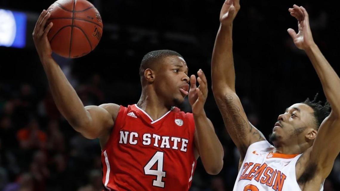 Former N.C. State guard Dennis Smith Jr. (4) passes around Clemson’s Marcquise Reed (2) during the second half of Clemson’s 75-61 victory over N.C. State in the ACC tournament at the Barclays Center in Brooklyn, N.Y., on March 7, 2017.