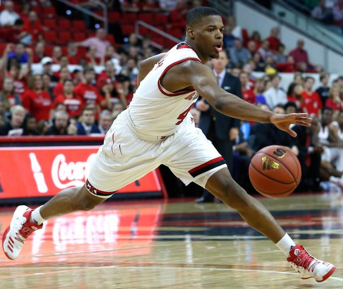 N.C. State's Dennis Smith Jr. (4) keeps control of a loose ball during N.C. State's game against Notre Dame at PNC Arena on Feb. 18, 2017.