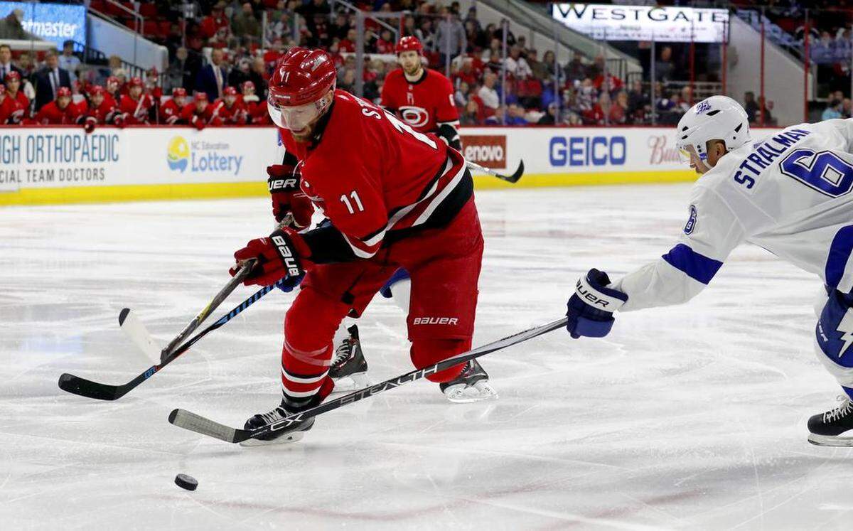 The Canes’ Jordan Staal (11) drives past the Lightning’s Anton Stralman (6) during the first period of 2018 game at PNC Arena,