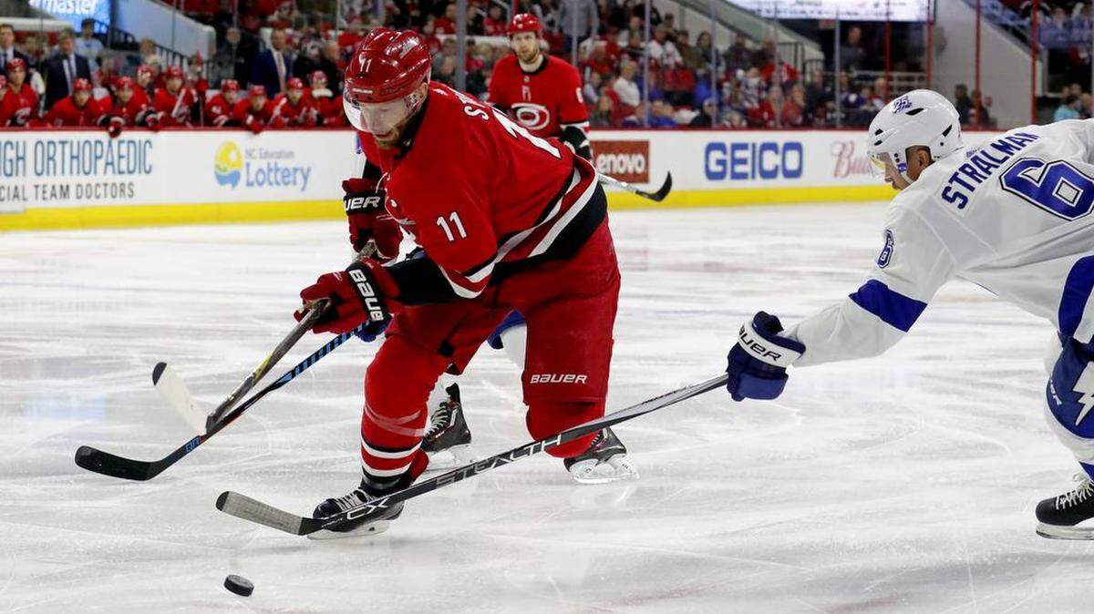 The Canes’ Jordan Staal (11) drives past the Lightning’s Anton Stralman (6) during the first period of 2018 game at PNC Arena,