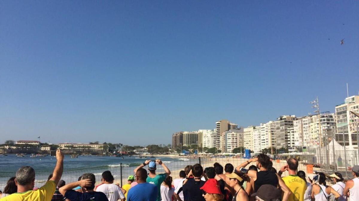 Curious Brazilians stand three deep at the edge of the spectator area to see the women’s marathon swimming competition Monday.
