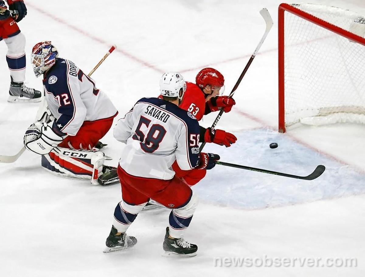The Canes' Jeff Skinner (53) celebrates after he scored against the Blue Jackets' Sergei Bobrovsky (72) and David Savard (58) to tie the score 1-1 in the final moments of regulation.