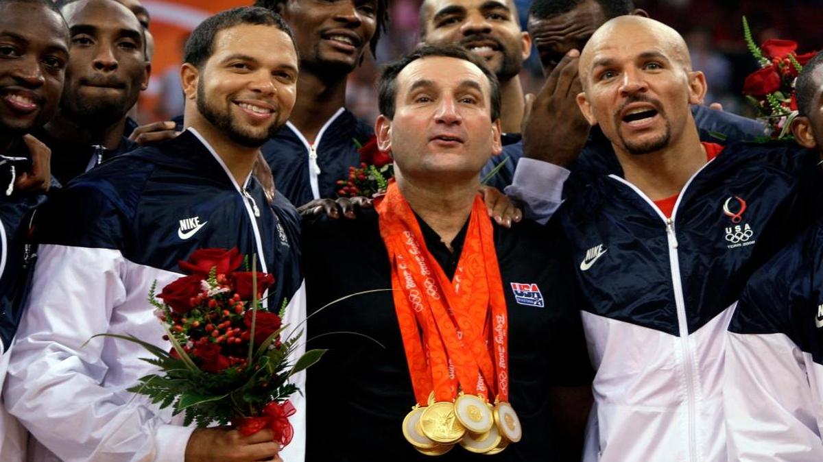 USA's coach Mike Krzyzewski, center, wears his players gold medals as they celebrate after beating Spain 118-107 in the men's gold medal basketball game at the Beijing 2008 Olympics in Beijing, Sunday, Aug. 24, 2008. Flanking Krzyzewski is Deron Williams, left, and Jason Kidd.