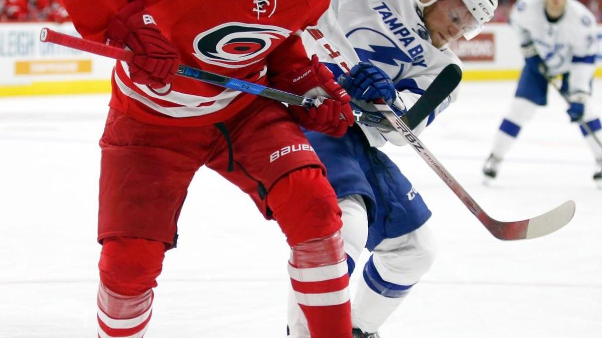 The Canes’ Victor Rask (49) battles the Lightning's Tanner Richard (38) on a face-off during the second period of their preseason game at PNC Arena in Raleigh, N.C. on Sept. 30, 2016.