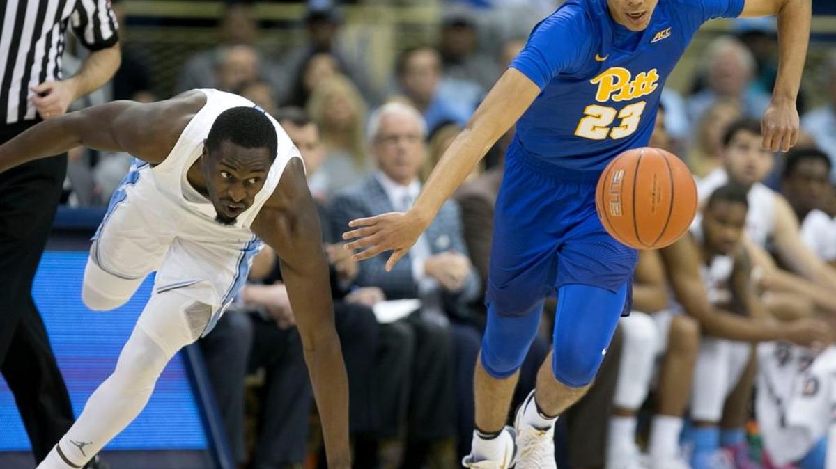 North Carolina’s Theo Pinson (1) and Pittsburgh’s Cameron Johnson (23) chase down a loose ball during on Feb. 25, 2017 at the Petersen Events Center in Pittsburgh, Pa.