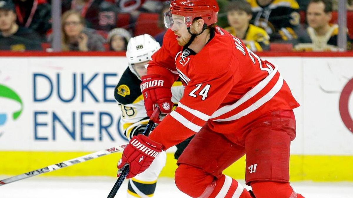 
The Canes Brad Malone (24) moves the puck against the Bruins David Pastrnak (88) during an NHL game at PNC Arena on March 29, 2015.
