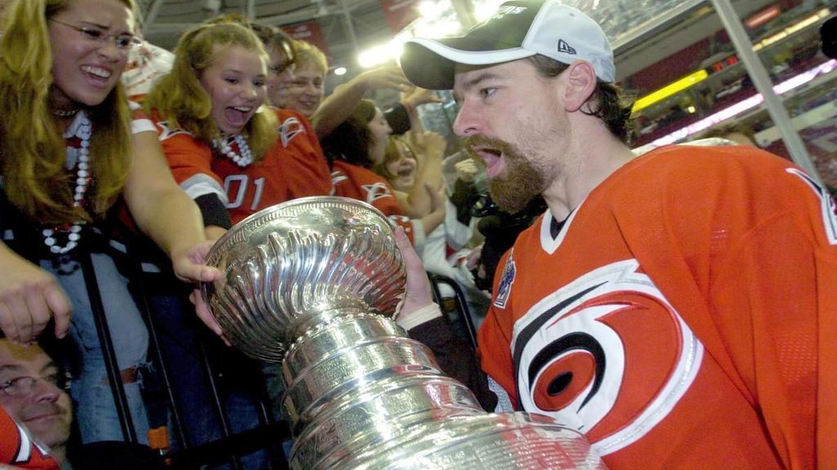 The Carolina Hurricanes Justin Williams is greeted by the fans as he carries the Stanley Cup off the ice in Raleigh on June 19, 2006. The Canes beat the Edmonton Oilers 3-1 in Game Seven of the Stanley Cup finals.