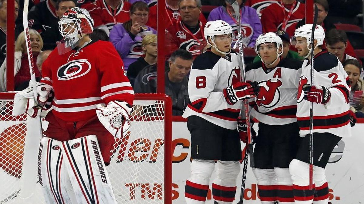 New Jersey Devils' Michael Cammalleri, center, celebrates his goal against Carolina Hurricanes goalie Eddie Lack (31) with teammates Beau Bennett (8) and John Moore (2) during the second period of the Devils’ 4-1 win.