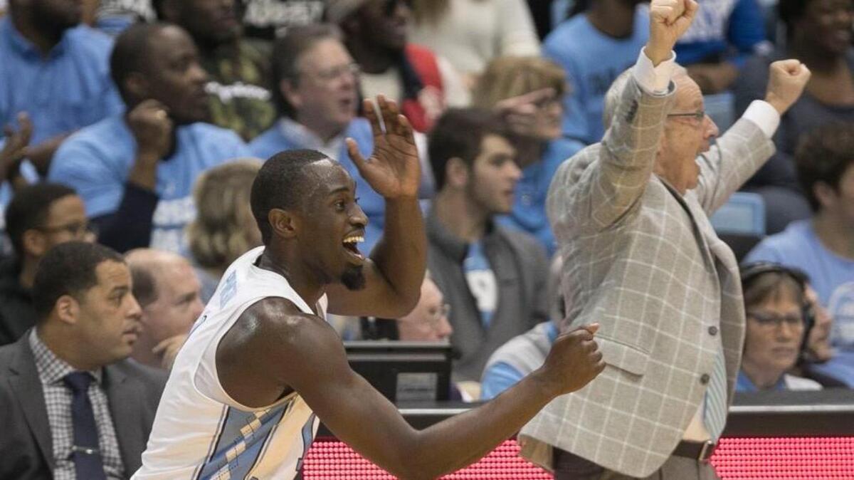 North Carolina’s Theo Pinson (1) and coach Roy Williams celebrate following a basket by walk-on player Kane Ma (14) with :24 seconds to to play against Georgia Tech on Saturday, January 20, 2018 at the Smith Center in Chapel Hill, N.C.