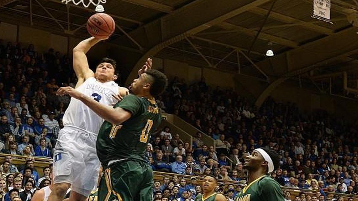 Duke guard Grayson Allen (3) goes in for a ferocious second half dunk against Siena during the Blue Devils 92-74 win at Cameron Indoor Stadium.