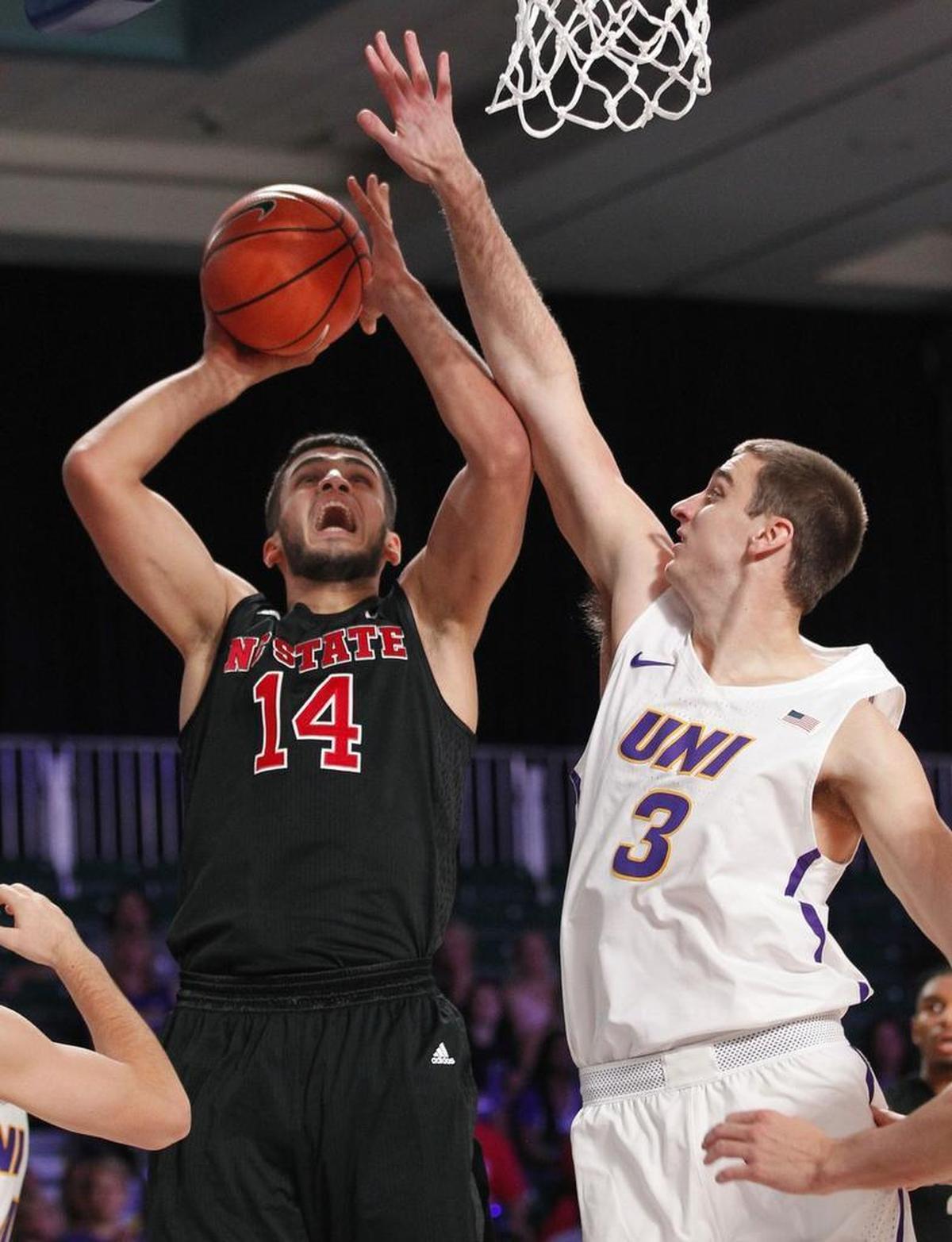 North Carolina State center Omer Yurtseven (14) shoots as Northern Iowa's Ted Friedman (3) and Spencer Haldeman, left, defend.