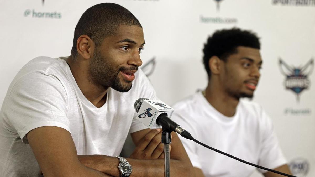 
The Charlotte Hornets’ Nicolas Batum (left) answers a question as Jeremy Lamb listens during a new conference in Charlotte in June. Batum is penciled in to start at shooting guard for the Hornets in 2015-16, according to coach Steve Clifford.
