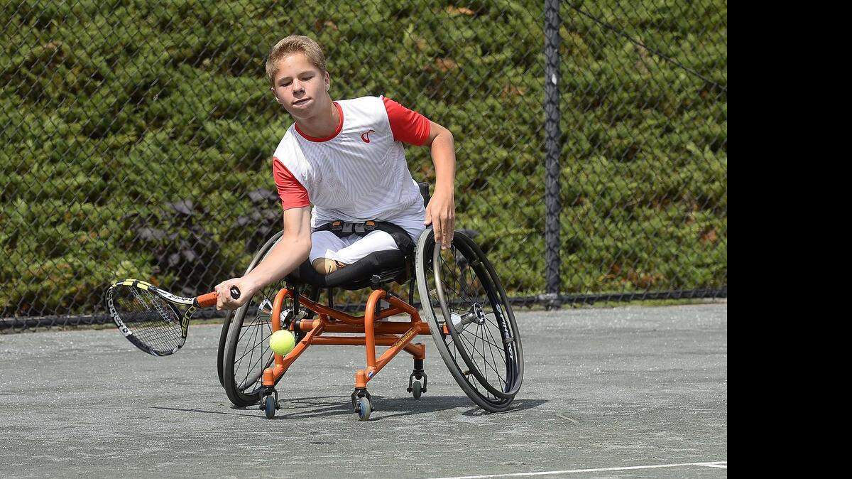 
Conner Stroud of Rutherfordton, N.C., has a non-hereditary birth defect called proximal femoral focal deficiency, or PFFD, that left him without legs. But he can’t remember a time before he played tennis, and he has risen to be one of the world’s top junior wheelchair players. Here he hits a low forehand with one hand while guiding his chair into position with the other.
