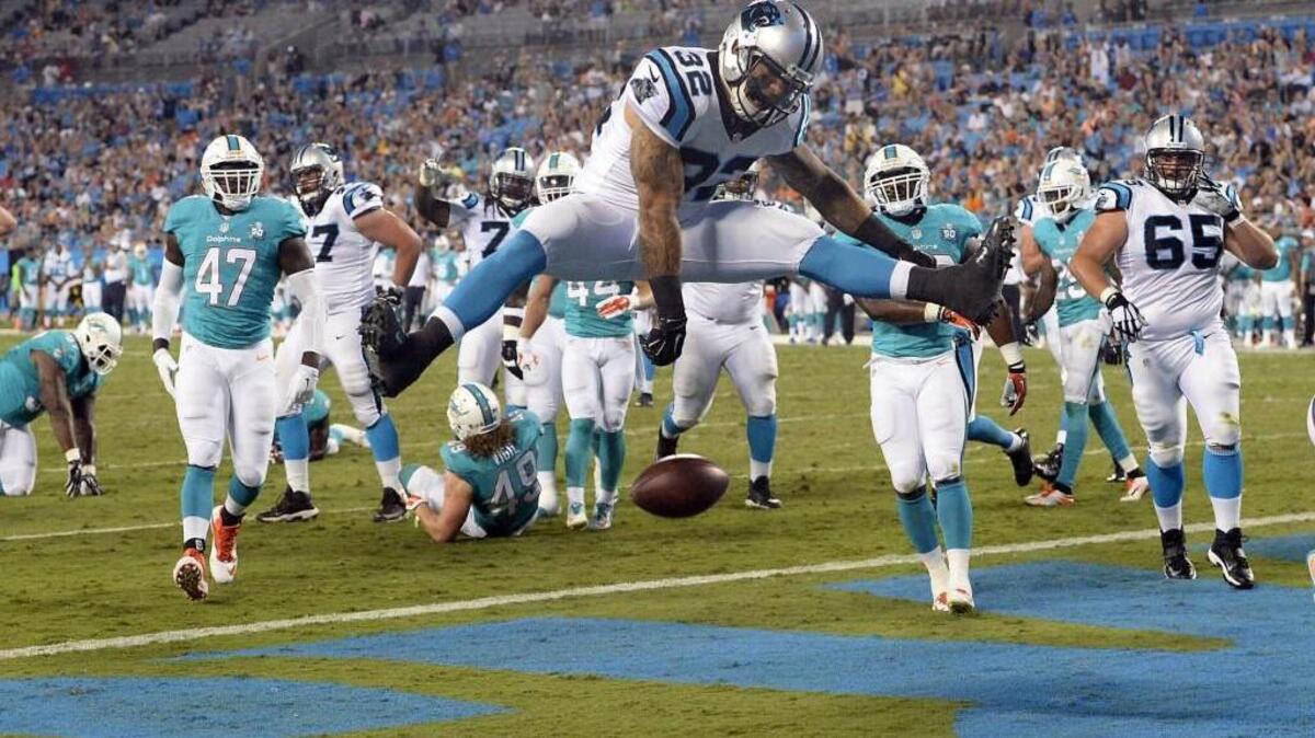 
Carolina’s Brandon Wegher (32) spiked the ball at his four-year-old son’s request after his first touchdown against Miami Saturday night. The Panthers won, 31-30.

