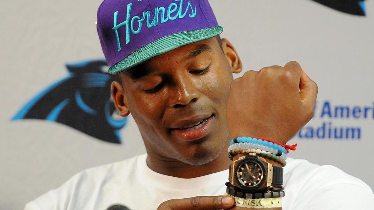 
Carolina Panthers quarterback Cam Newton discusses his hospital bracelet that he received following his car accident last year during a news conference at Wofford College in Spartanburg, SC Friday, July 31, 2015. Newton continues to wear the bracelet as a reminder. 

