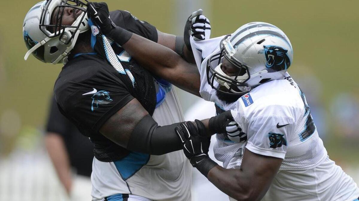
Steve Miller, right, battles with Tony Hills during a drill at the Carolina Panthers’ training camp.
