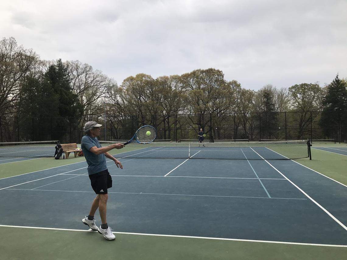 Larry Meisner of Raleigh, left, returns a serve from Richard Epstein of Raleigh on Friday, March 27 as the two played a few sets of tennis at Pullen Park.