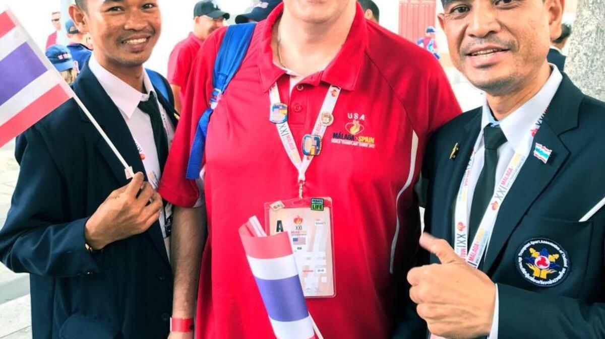 Brian Barndt, center, poses with two athletes from Team Thailand before the procession for the opening ceremonies for the World Transplant Games in Malaga, Spain Sunday, June 25, 2017.
