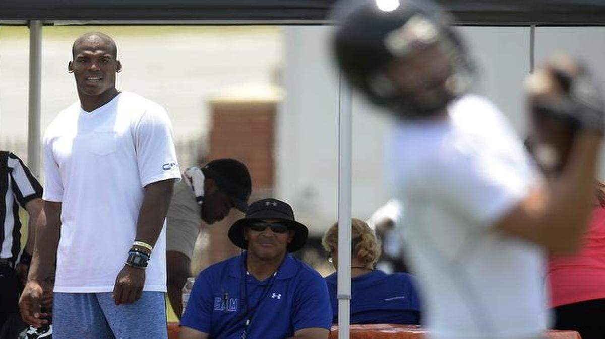 
Carolina Panthers quarterback Cam Newton, center, watches teams play during the first day of the Cam Newton Foundation 7 v 7 High School Football Tournament Championship at Nation Ford High in Fort Mill on Friday.
