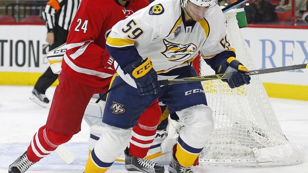The Nashville Predators' Roman Josi (59) and the Carolina Hurricanes' Brad Malone (24) go for the puck during the second period.